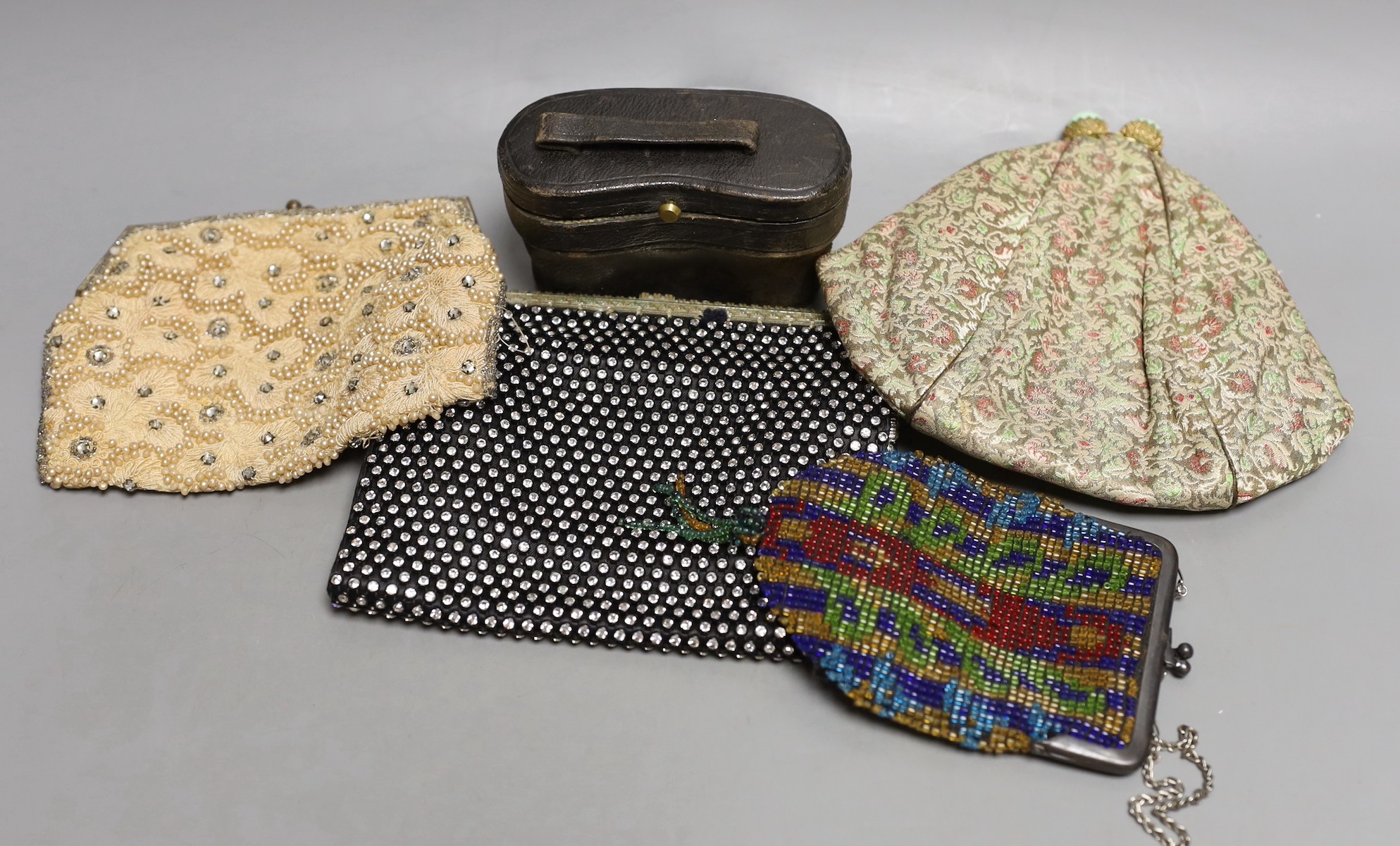 Four assorted lady's evening bags and a pair of cased opera glasses.